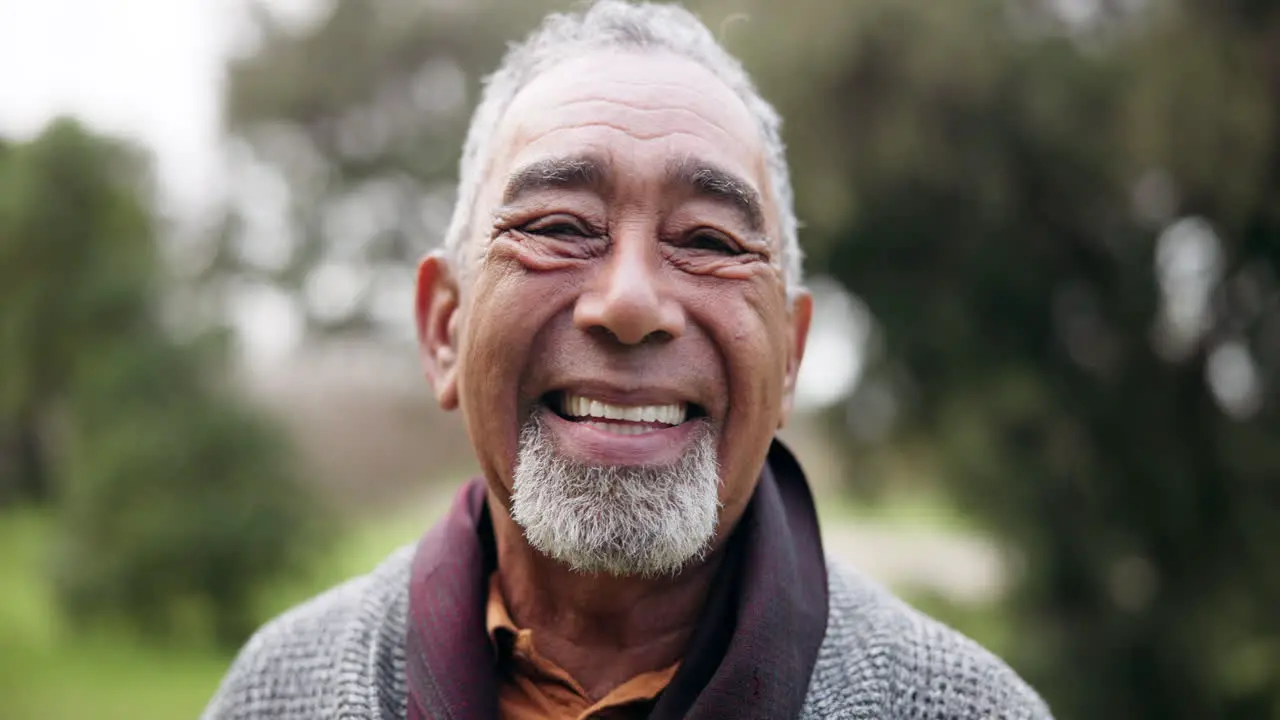 Senior man smile and face closeup in a nature