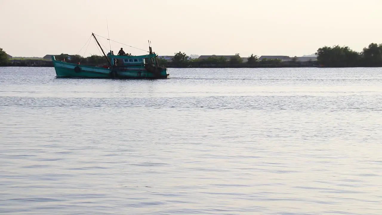 Khmer fishing boat heading out to sea in Kampot Cambodia that shows the authentic life livelihood and culture of the Cambodian people