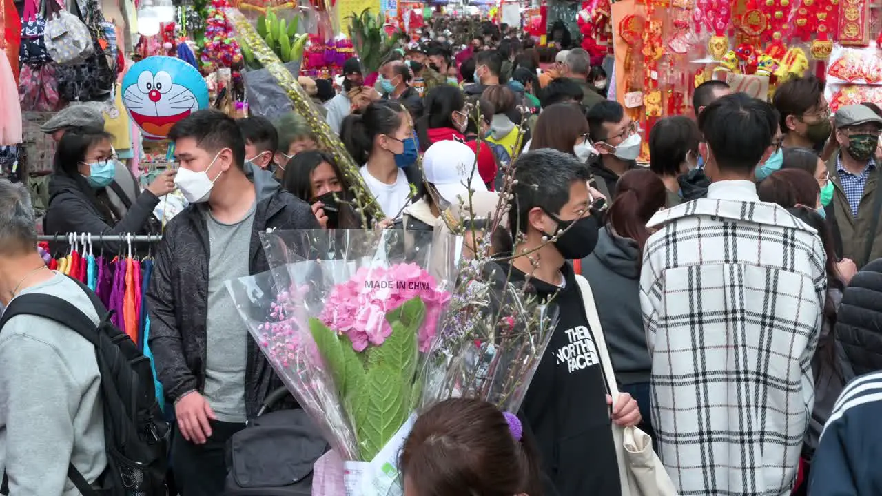 People shop for Chinese New Year ornaments and gifts for sale seen at street market stalls during the Lunar Chinese New Year in Hong Kong