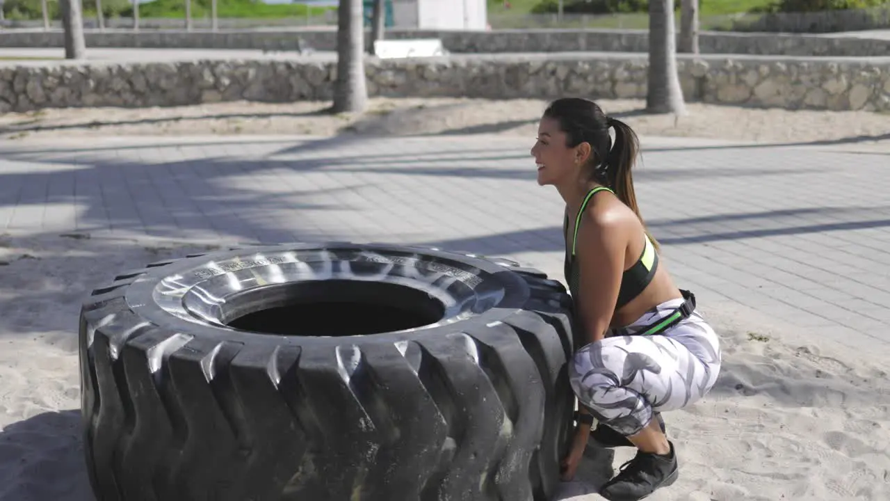 Woman trying to lift the tire