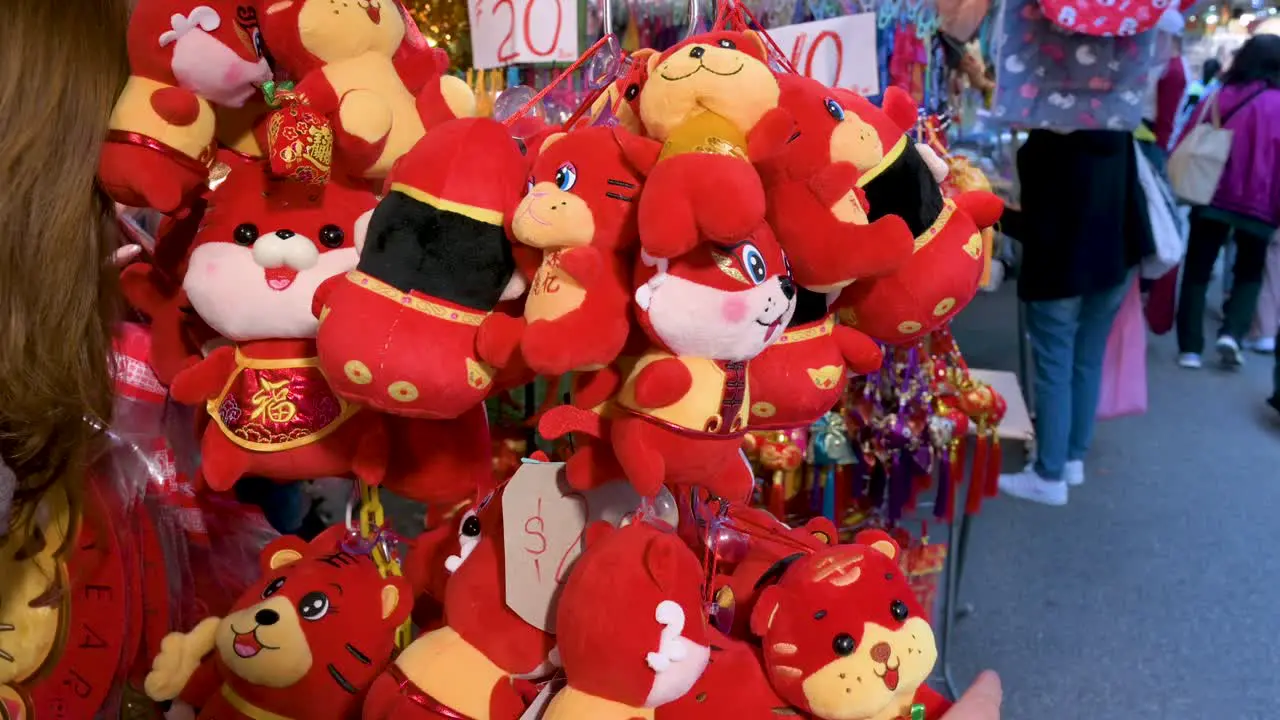 Chinese buyers shop for Chinese New Year ornaments and gifts at a street market stall during the Lunar Chinese New Year in Hong Kong