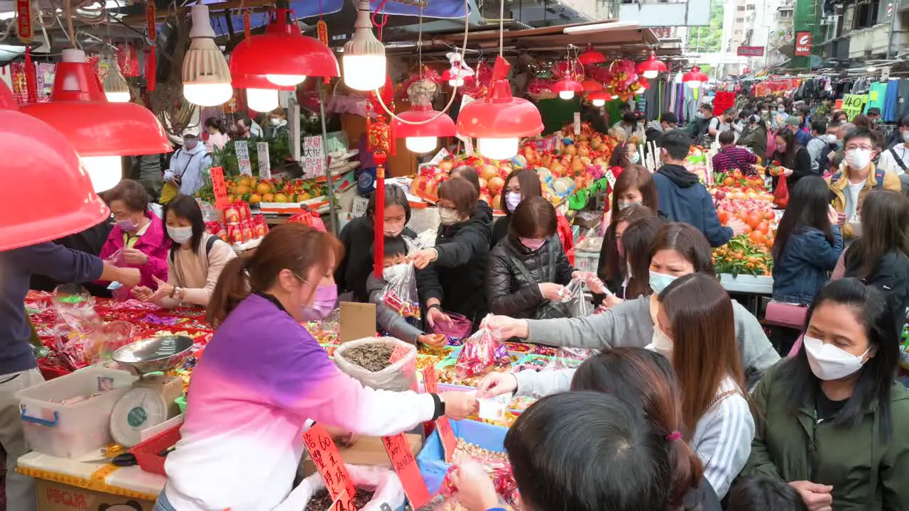 Customers shop for fruits food and candies at street market stalls for the upcoming Chinese Lunar New Year festivities and celebrations in Hong Kong