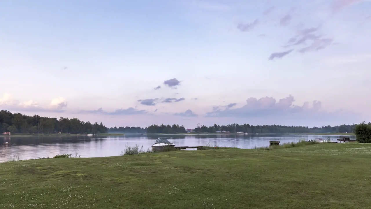 Green Grass Shoreline and Finnish Archipelago Under Dramatic Summer Sky at midnight concept of nordic cottage culture