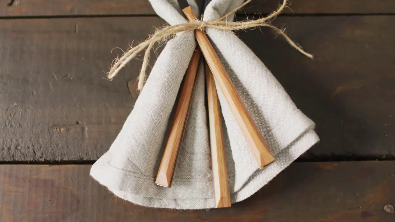 Video of cutlery and cloth lying on wooden surface