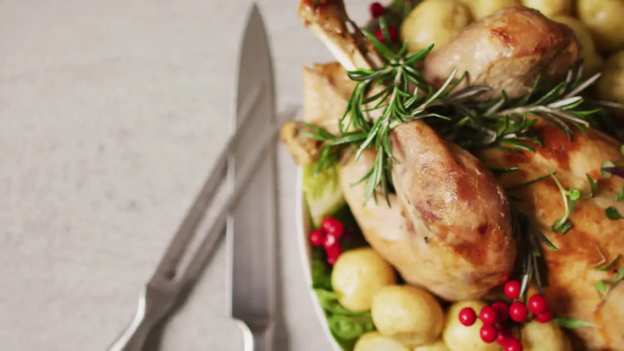 Video of tray with roasted turkey potatoes and cutlery on white surface