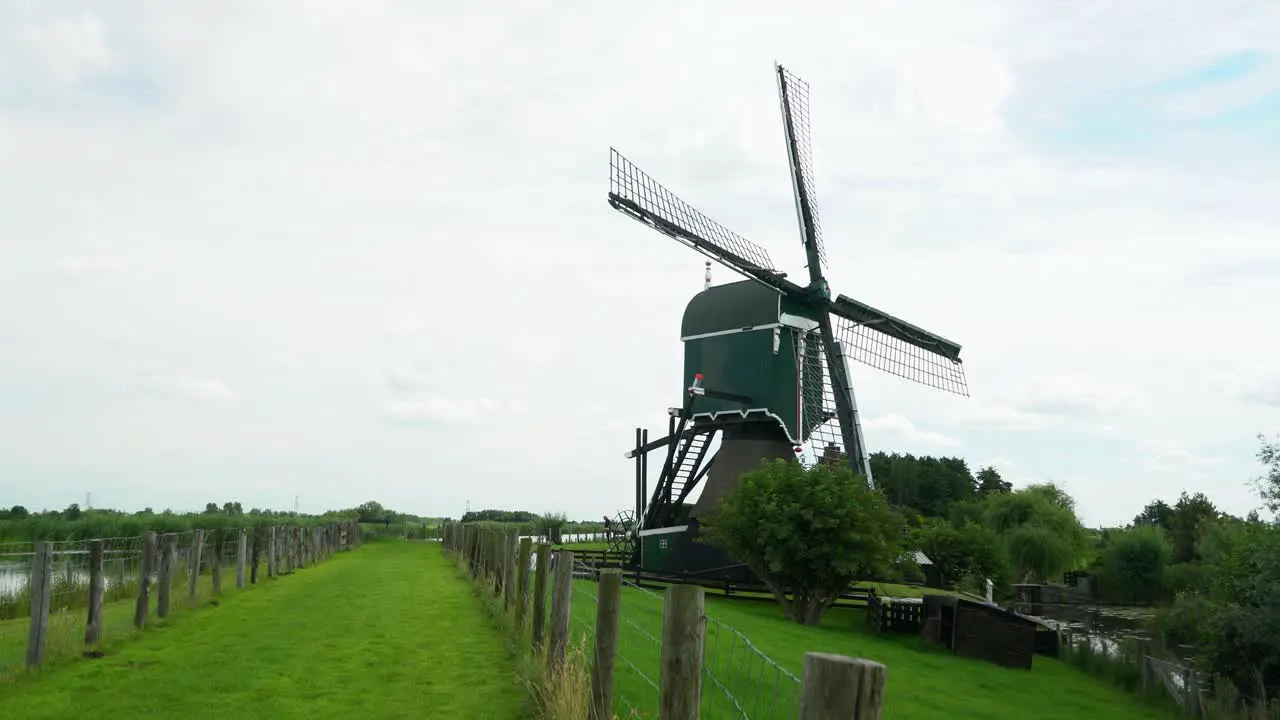 4k Windmill Oukoopse Molen standing in typical Dutch nature with green lands dutch culture leadinglines