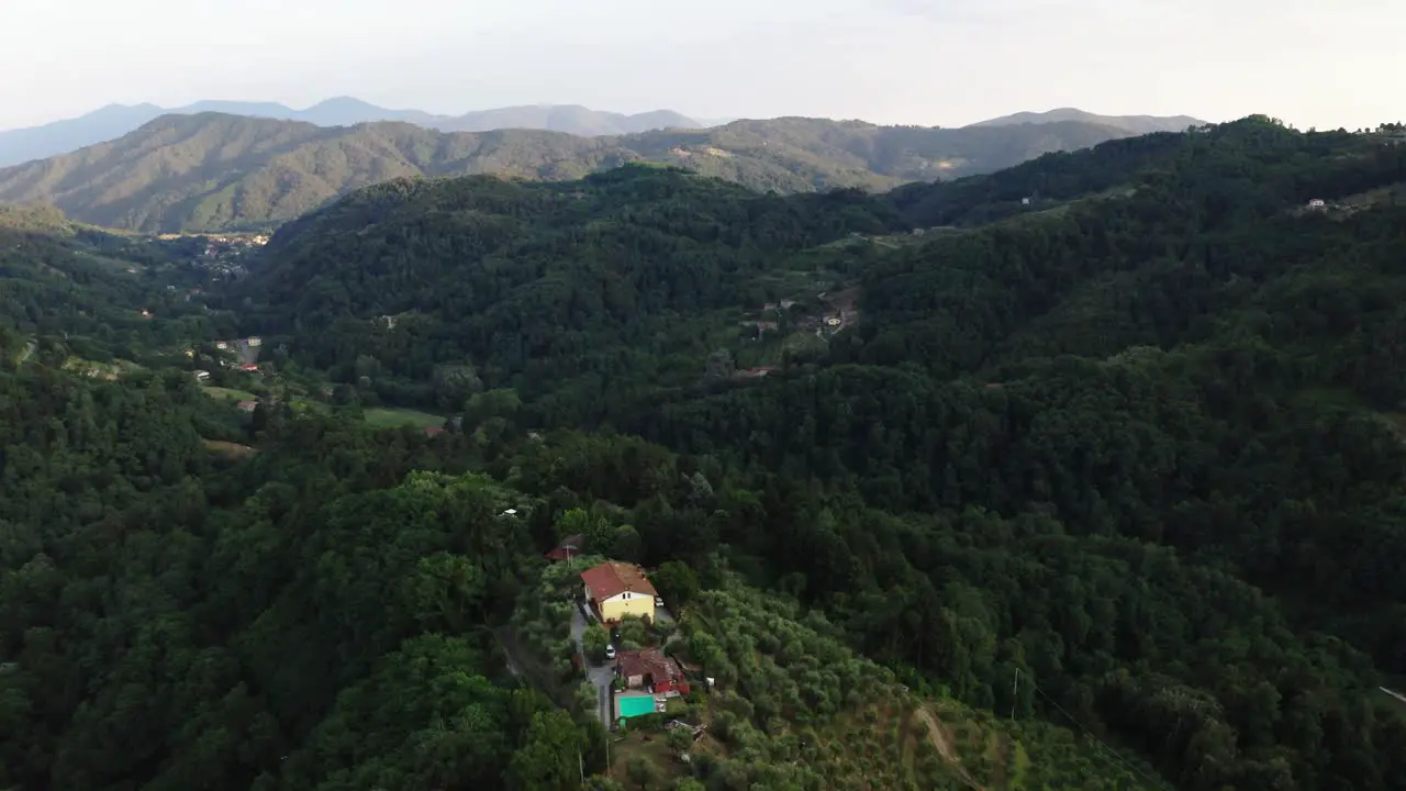 Aerial view of Tuscany rolling hills house at sunset Italy