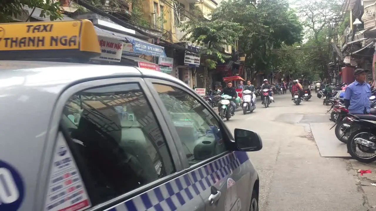 Cars bikes and busy traffic in Hanoi Vietnam