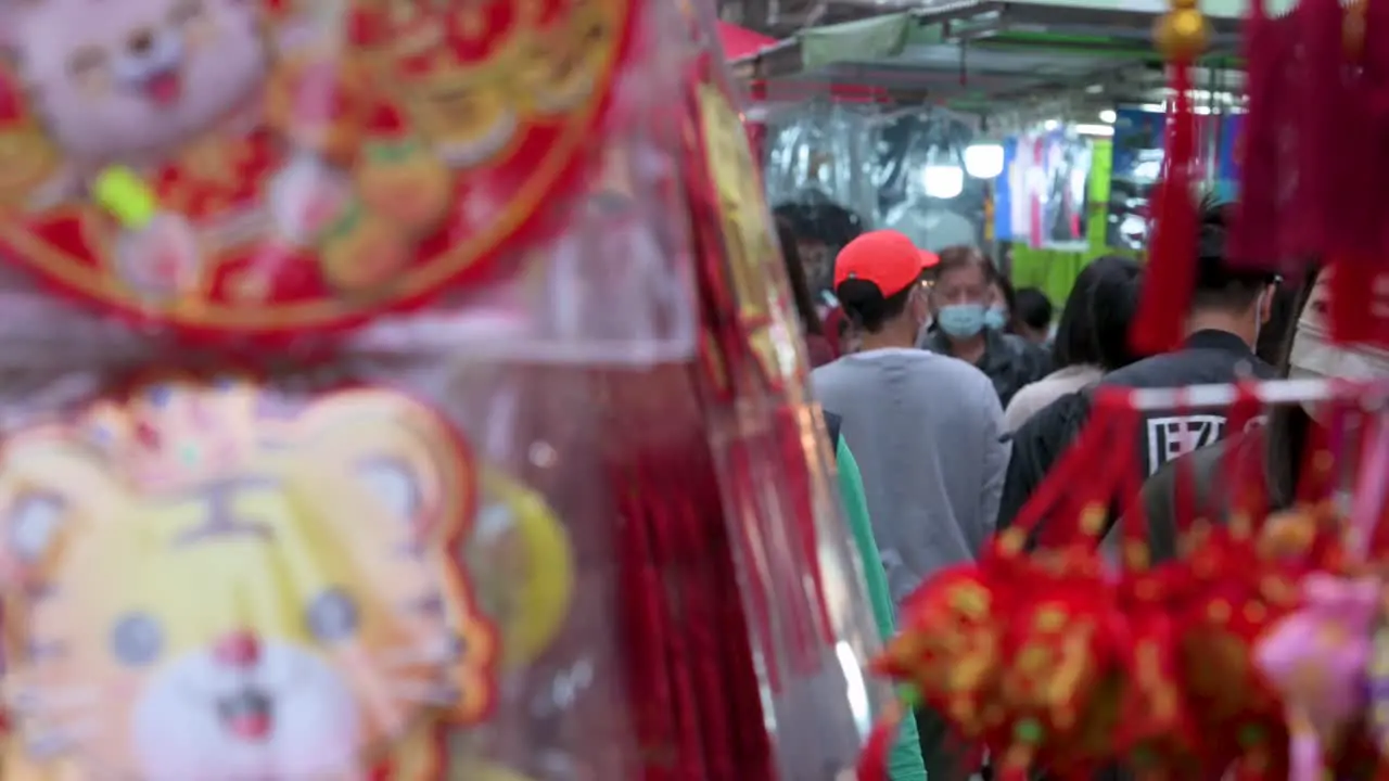 Shoppers buy Chinese New Year decorative ornaments and gifts at a street market during the preparation for the Chinese New Year celebration and festivities