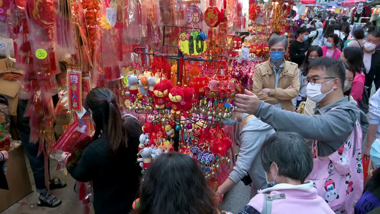 Chinese buyers shop for Chinese New Year decorative ornaments goods at a street market during the preparation ahead of the Chinese New Year celebration and festivities