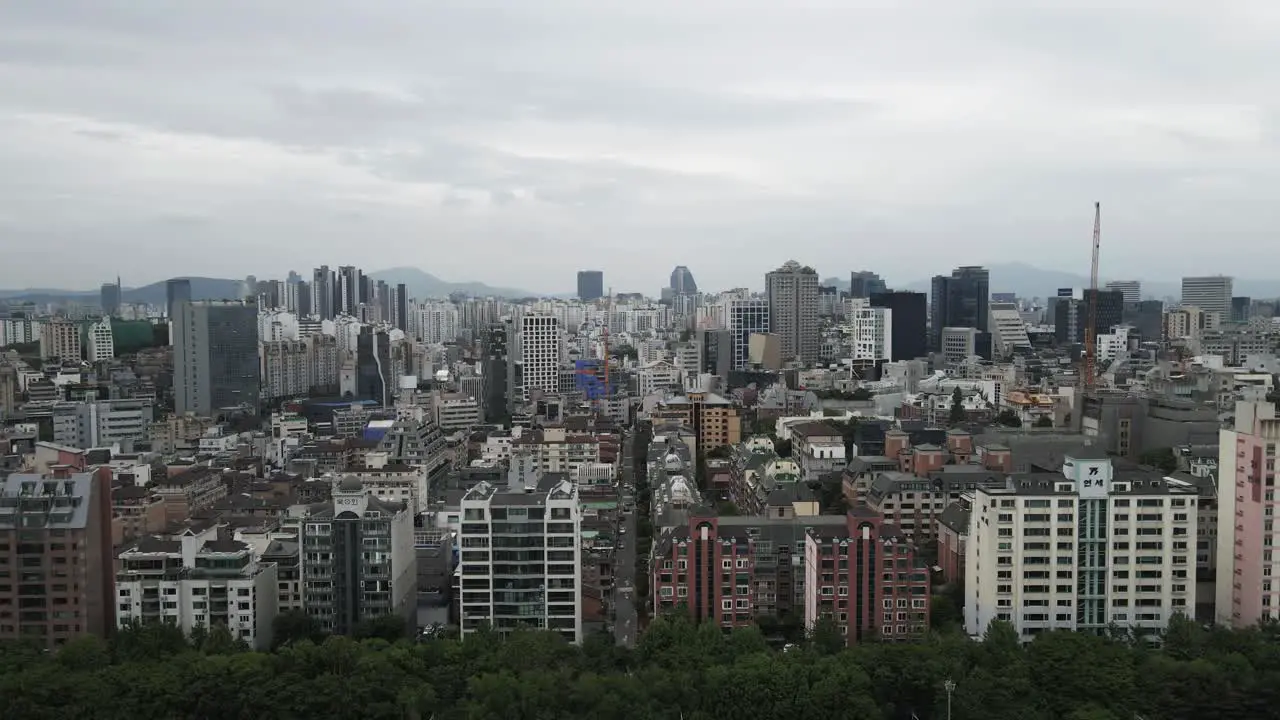 Aerial shot flying over densely populated built up city area Seoul South Korea