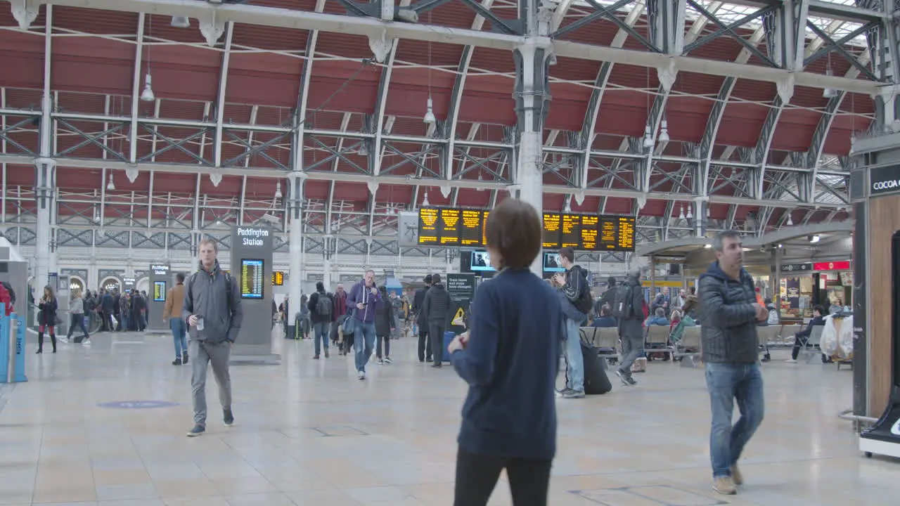 Commuters walk through Paddington Station in slow motion