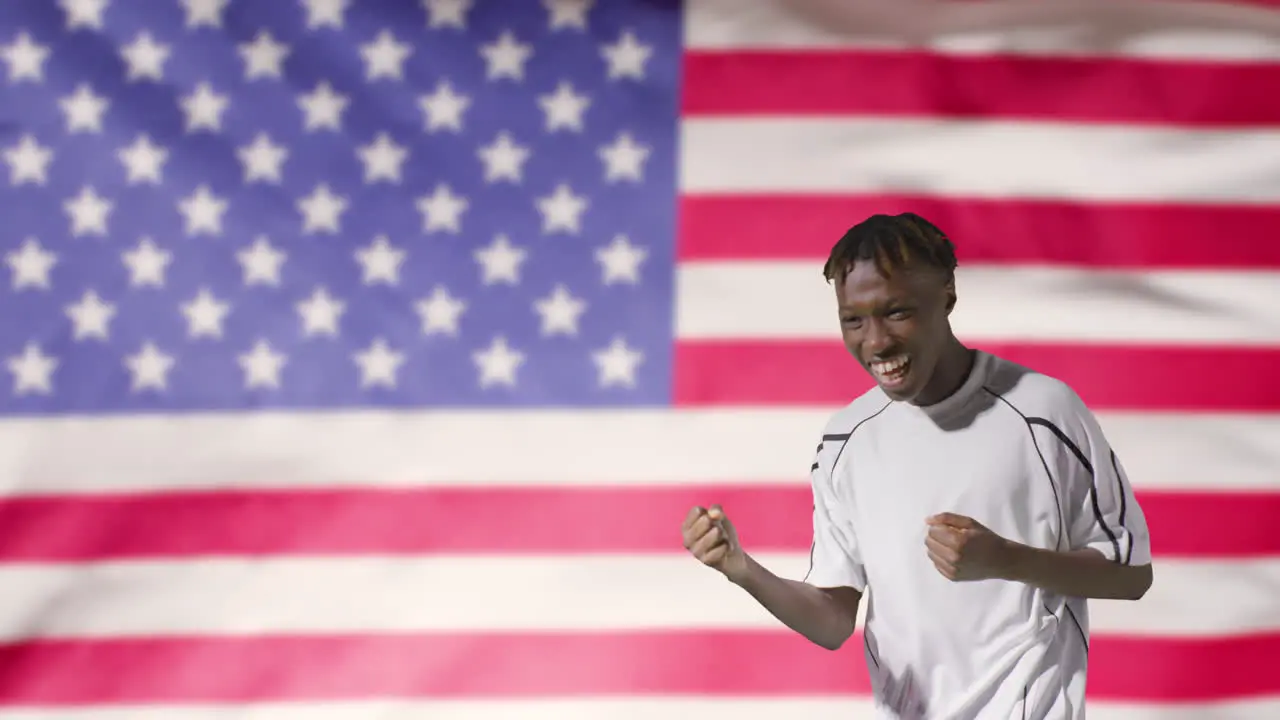 Young Footballer Celebrating to Camera In Front of USA Flag 01