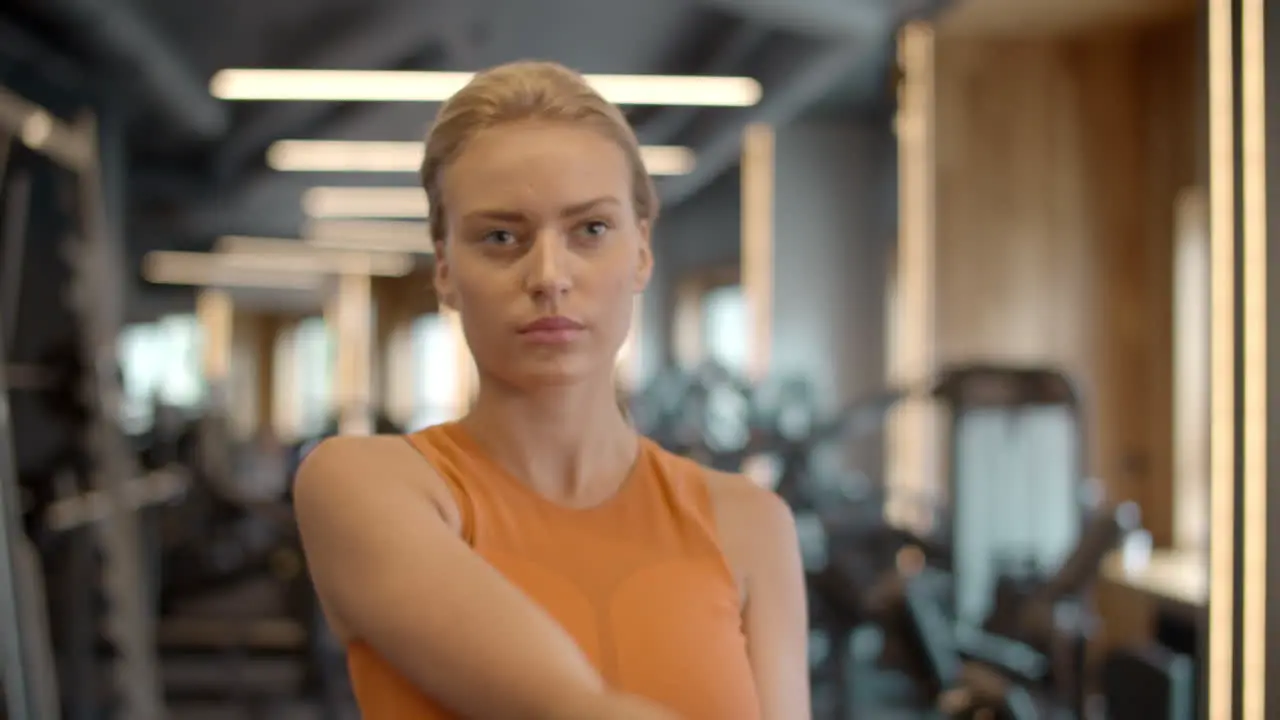 Attractive athlete girl training in sport club Sportswoman warming up at gym