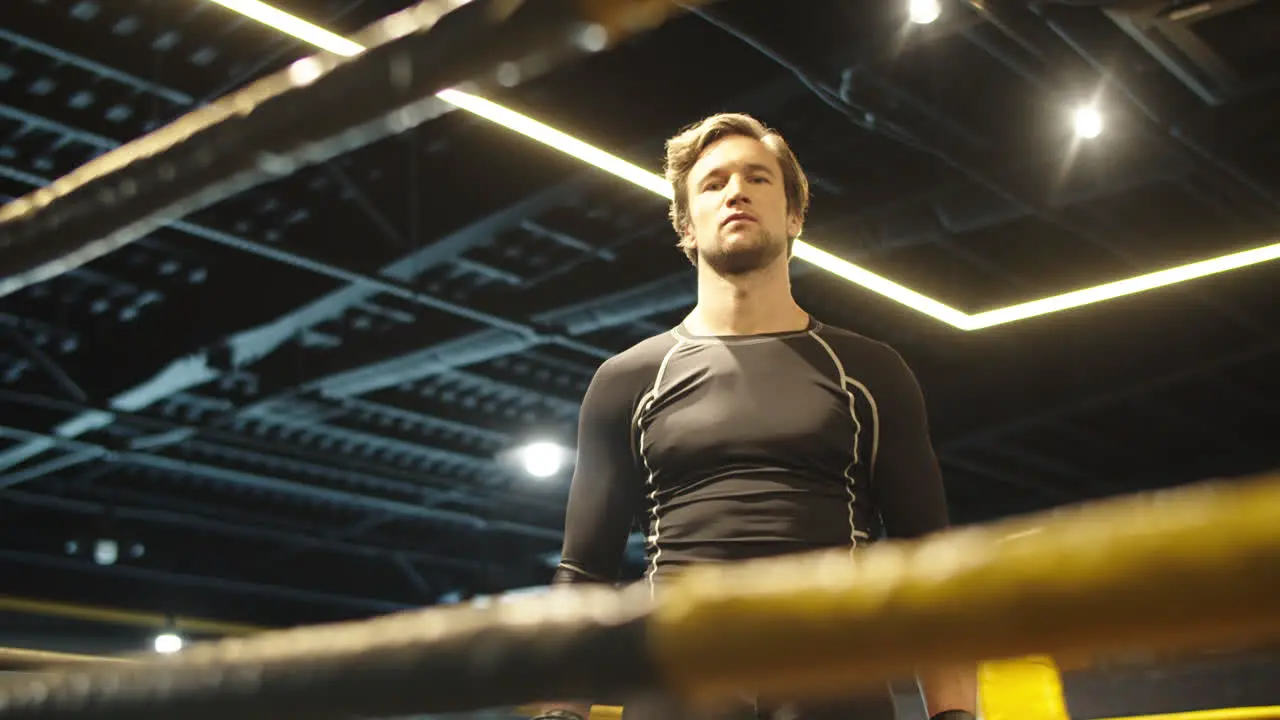 Agitated sport man getting ready for box at gym Fit man hitting fists on ring