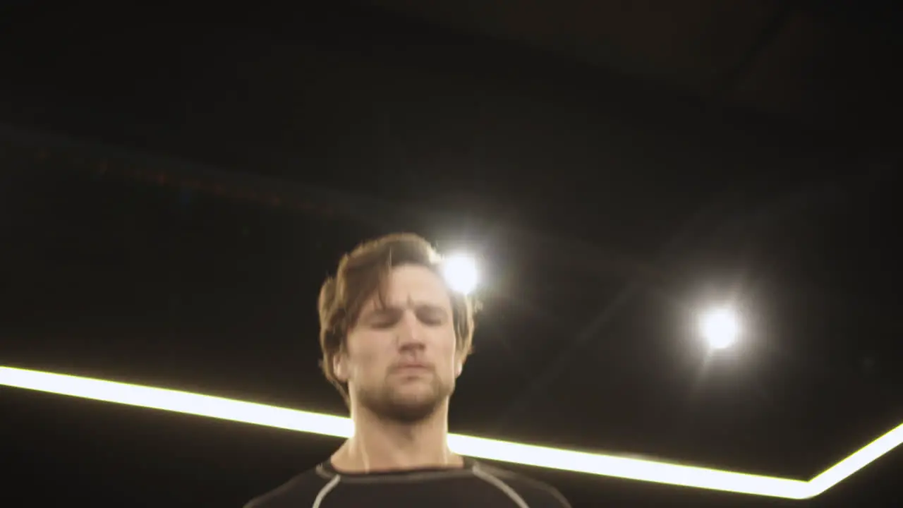 Handsome sport man jumping at gym Boxer training with skipping rope on ring