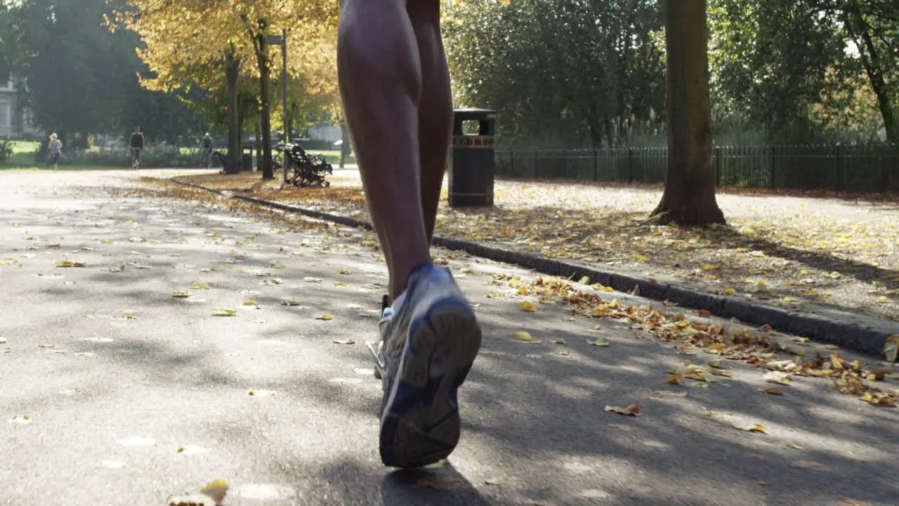 close up feet Group of runners running in park wearing wearable technology connected devices