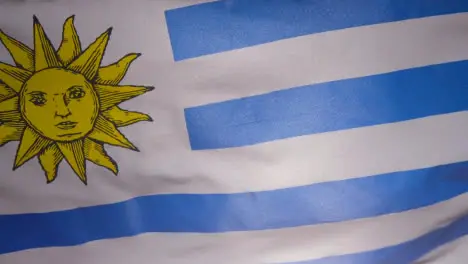 Close Up Studio Shot Of Uruguayan Flag Flying Filling Frame