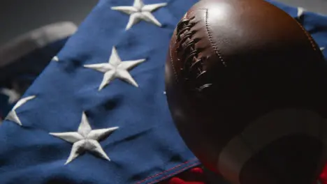 Close Up Studio Shot Of American Football On Stars And Stripes Flag 4