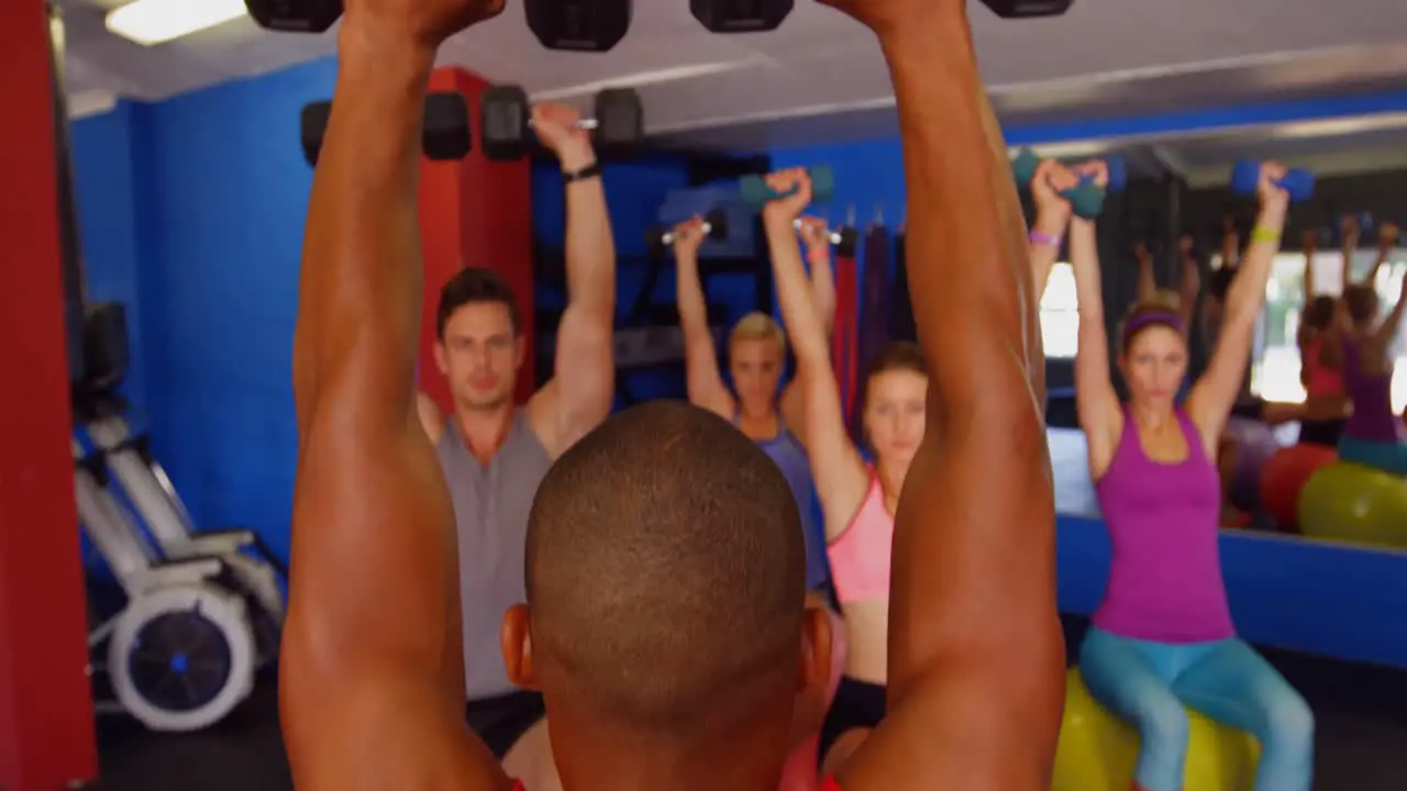 Group of people exercising with dumbbell