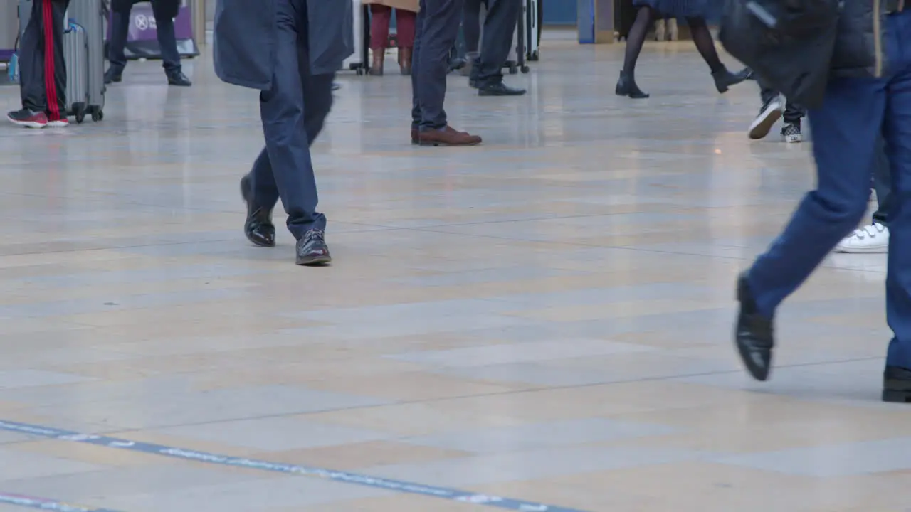 CU Feet walking in busy train station in slow motion