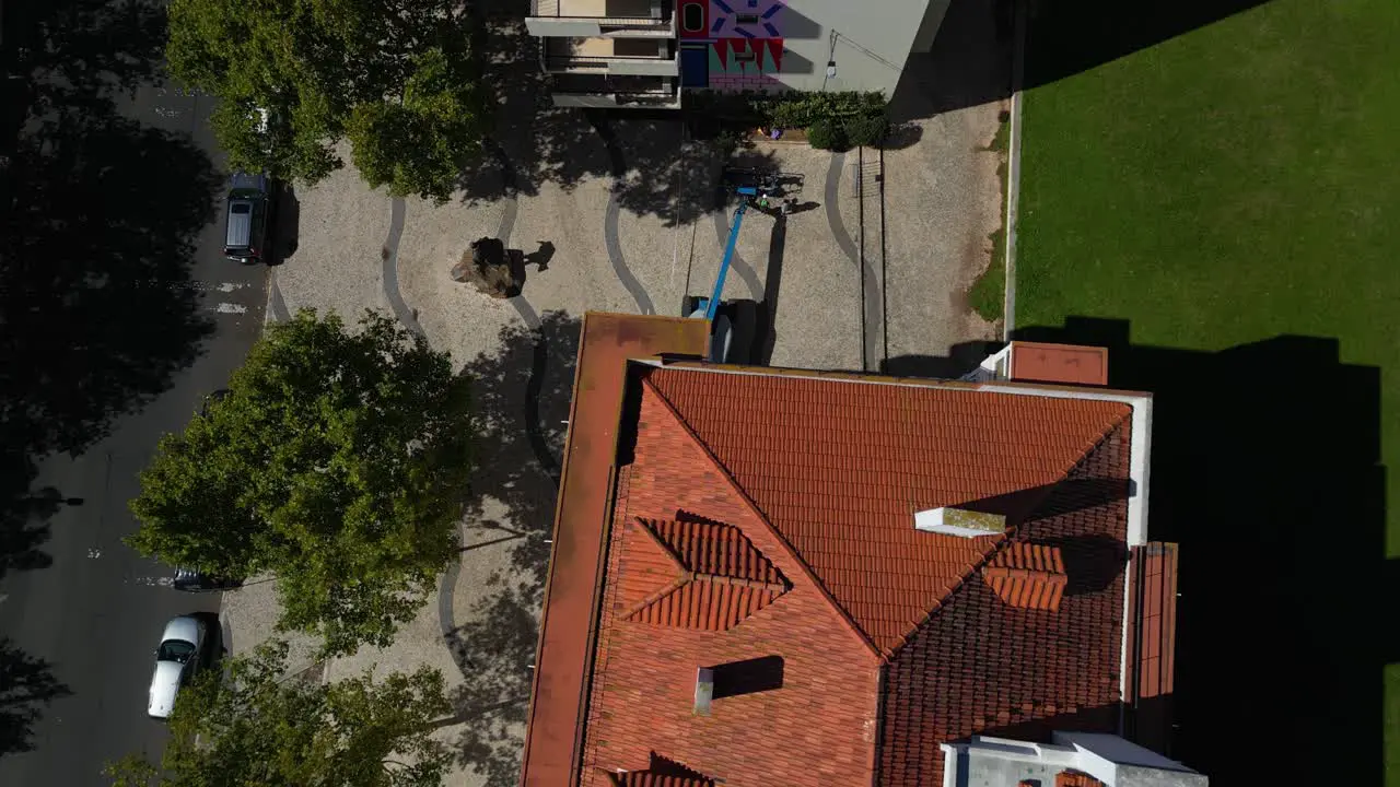 aerial view highlights an apartment building with a distinctive mural on its side adding artistic flair to the urban scene