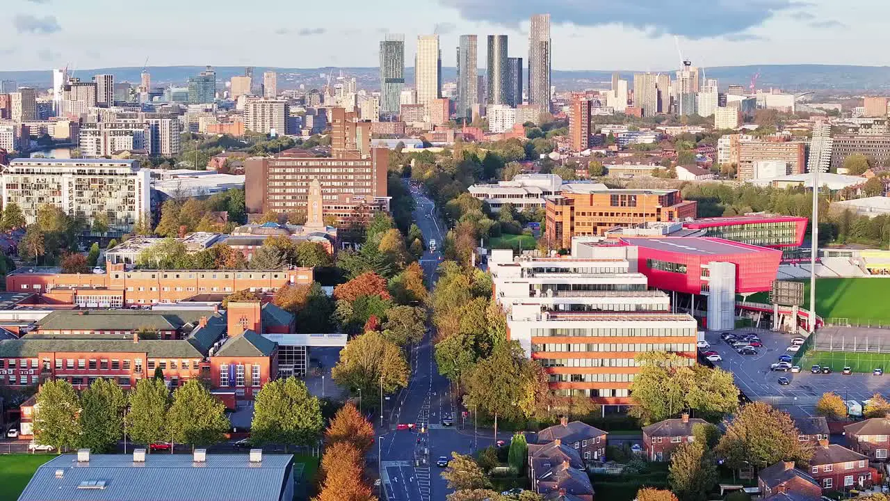 Drone shot rising over Manchester City skyline on sunny day in England