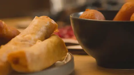 Close Up Of Spring Rolls And Gulab Jamun On Muslim Family Table In Home Set For Meal Celebrating Eid