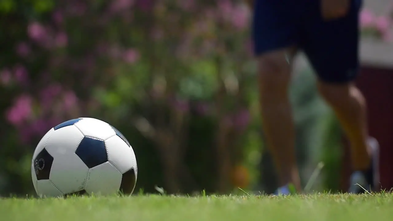 Man kicking a football outdoor