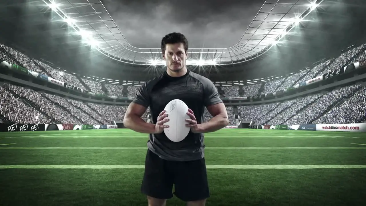 Serious rugby player holding rugby ball