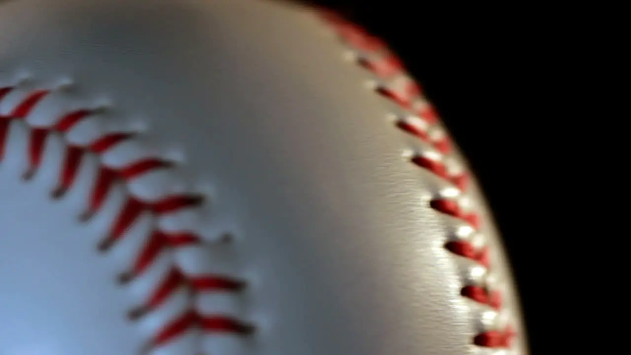 Baseball ball isolated on black background Red seam on white ball