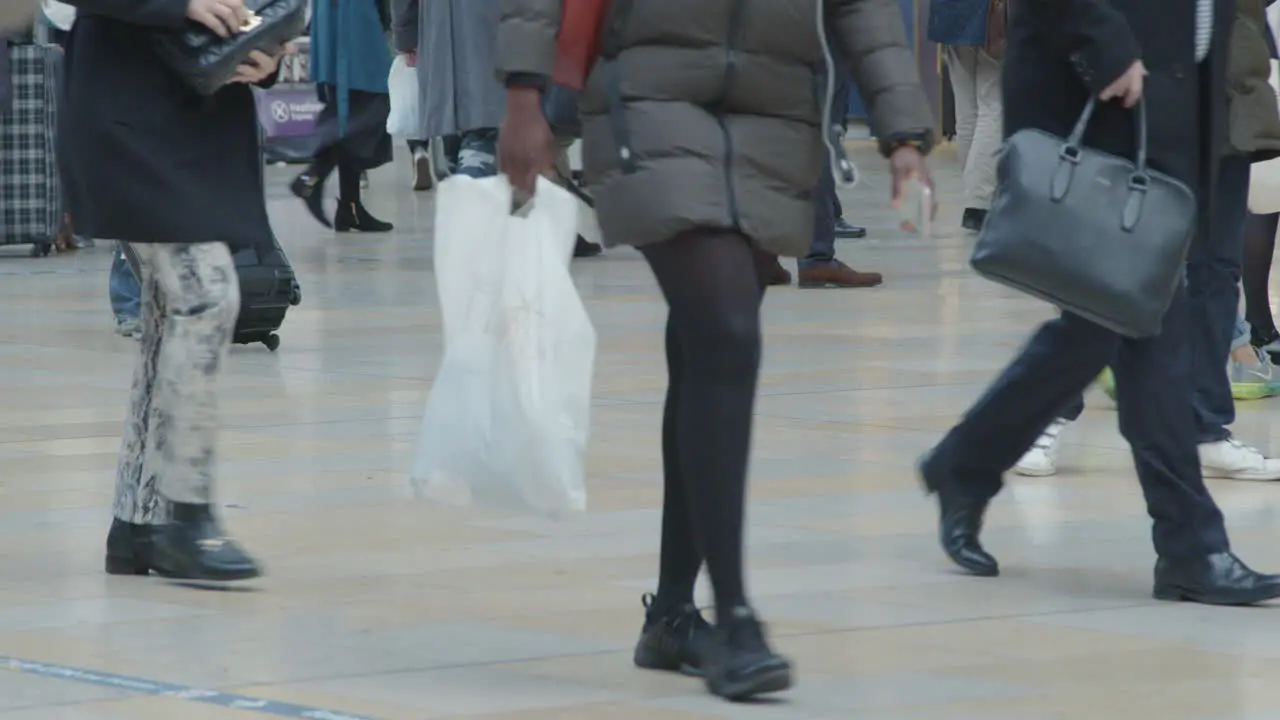 Feet walking in busy train station in slow motion 