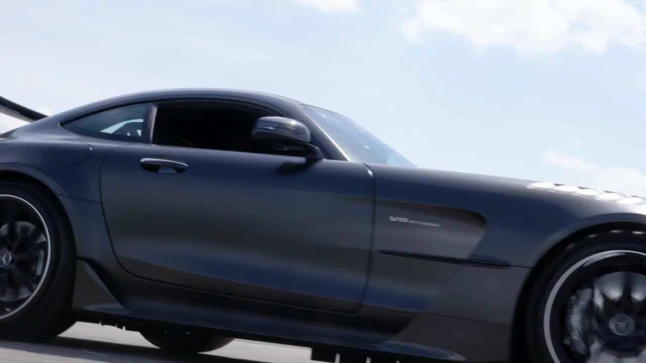 Beautiful black sport car driving on a road low angle shot