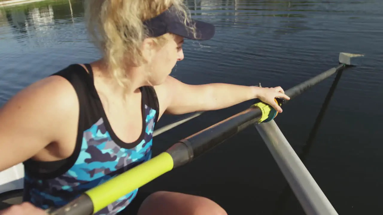 Female rower in a boat on a river