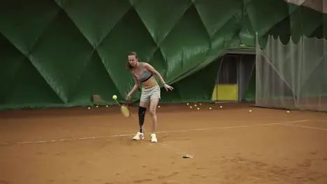 Attractive young disabled woman exercising She kicks the ball on the elastic band that comes back Training Slow motion