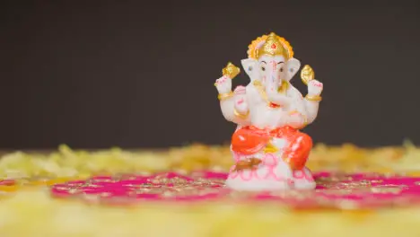 Statue Of Ganesh On Table Decorated For Celebrating Festival Of Diwali