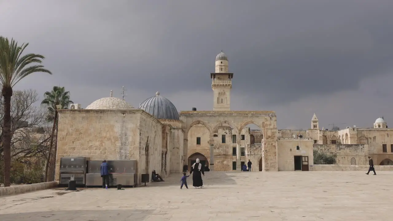 Muslim Woman Holding Childs hand walking into a mosque ethnic culture Editorial Dome of the rock Jerusalem Israel Nov