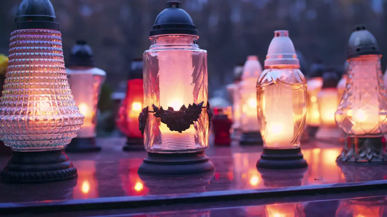 Burning grave candles standing on a grave