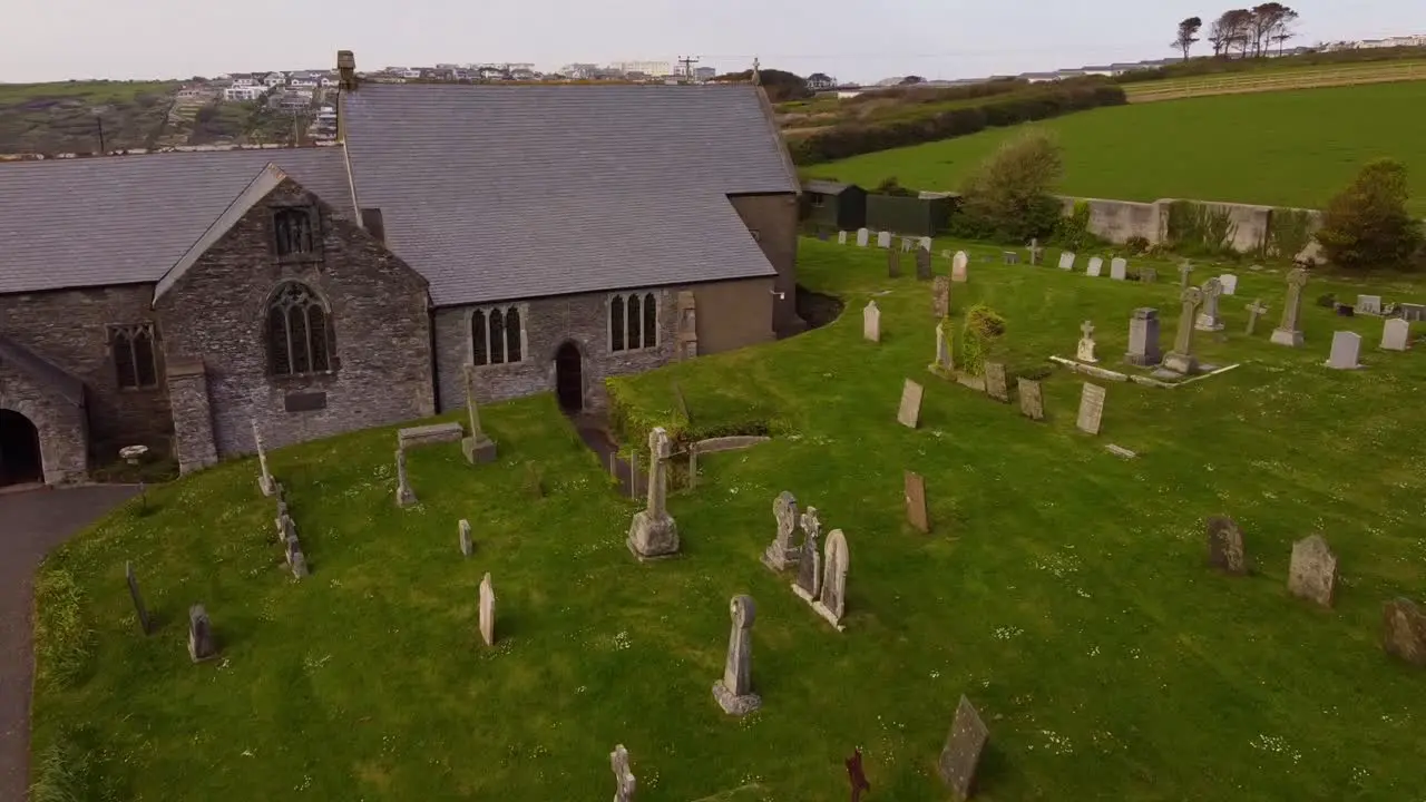 Aerial swoop across Crantock churchyard Cemetery graveyard