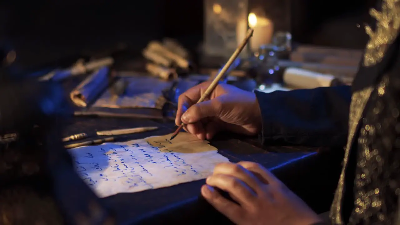 Man writing in arabic by candlelight