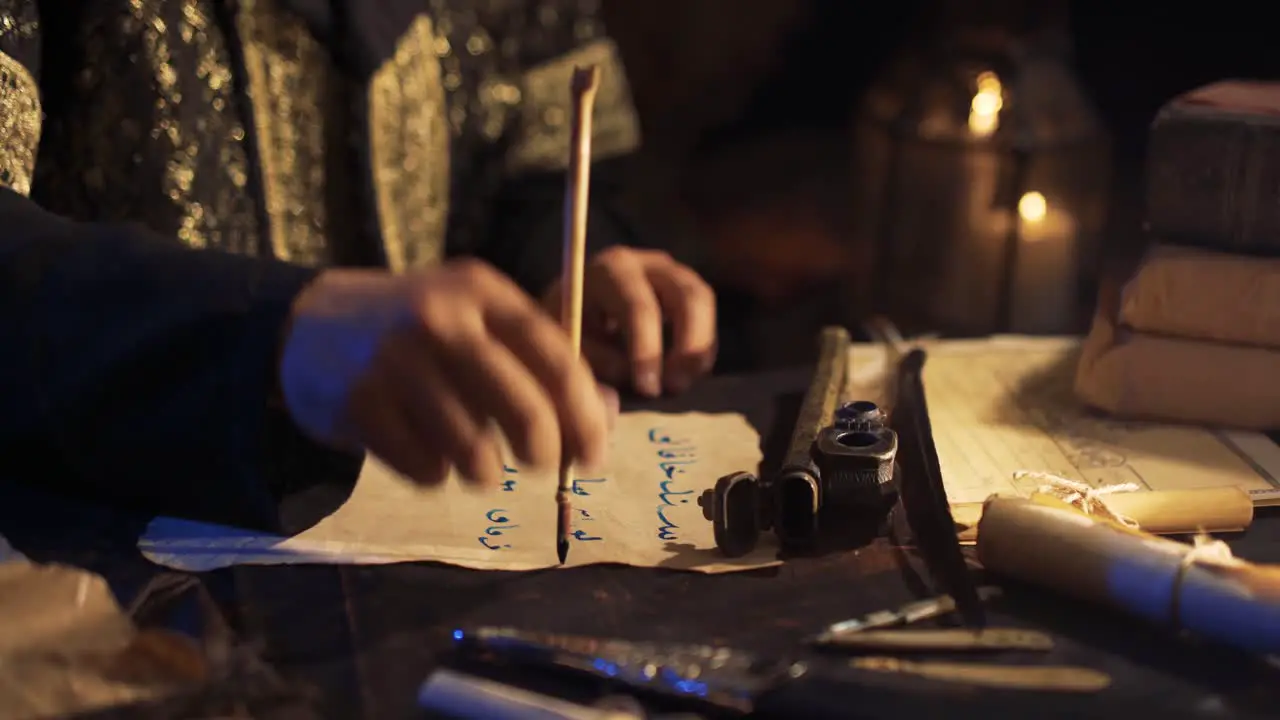 Taking out a pen from the inkwell Writing letters in ancient times