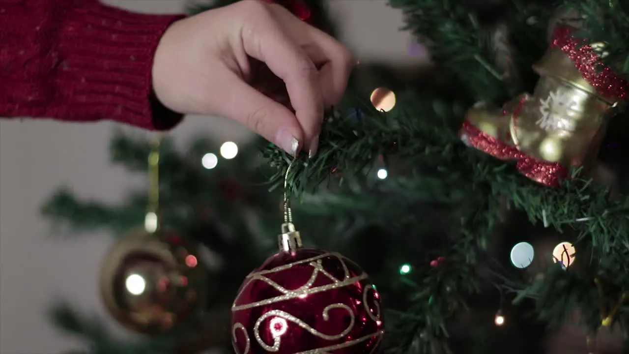 Person hanging up Christmas ornaments and decorations