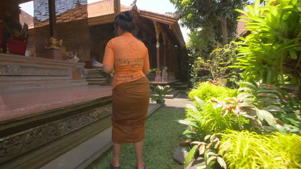 Woman Arranging Offerings in a Temple