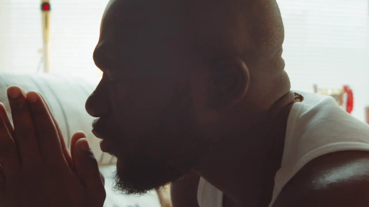 African American Man Saying Prayers at Home