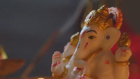 Close Up Of Statue Of Ganesh With Incense Burning Celebrating Festival Of Diwali