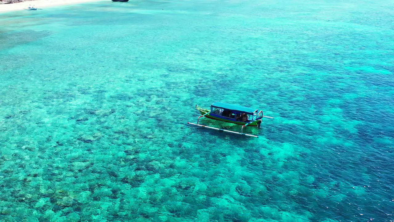 tropical exotic beach with the lonely boat floating on perfect pure turquoise lagoon ocean water