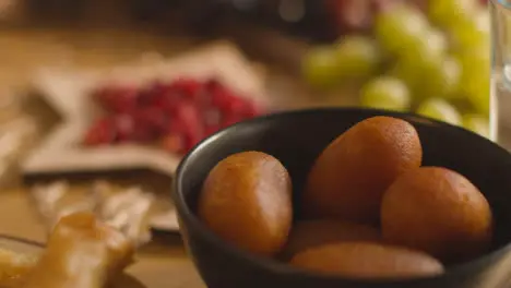 Close Up Of Food On Muslim Family Table In Home Set For Meal Celebrating Eid 4