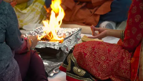 Close Up Of Worshippers Offer Smaghri Into Fire In Havan Ceremony For Navratri