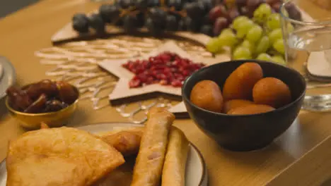 Close Up Of Food On Muslim Family Table In Home Set For Meal Celebrating Eid 13