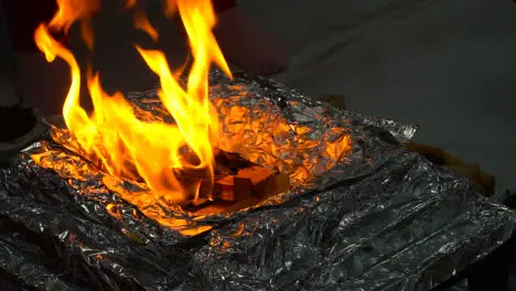 Worshipper Putting Ghee Onto Flames Of Fire During Hindu Havan Ceremony